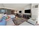 Modern living room with sleek furniture, a large TV, and a view into the kitchen area at 4381 W Flamingo Rd # 1609, Las Vegas, NV 89103