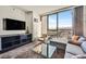 Relax in the open living space with a comfortable sectional sofa, chair, coffee table, and spectacular city views at 4381 W Flamingo Rd # 1609, Las Vegas, NV 89103