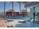 Relaxing pool area with shallow sunbathing area, lounge chairs and cabana-style seating at 4381 W Flamingo Rd # 1609, Las Vegas, NV 89103
