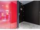Hallway of the home featuring a dark door, a bright red door, and marble-like flooring at 4381 W Flamingo Rd # 1809, Las Vegas, NV 89103