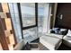 Cozy living room featuring a comfortable sectional sofa, city views, and floor to ceiling windows at 4381 W Flamingo Rd # 1809, Las Vegas, NV 89103