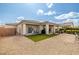 An inviting backyard with a patio, featuring a meticulously maintained artificial lawn and ample gravel space at 5224 E San Palo Dr, Pahrump, NV 89061