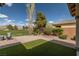 A landscaped backyard with artificial turf, offering golf course views and a serene outdoor space at 5224 E San Palo Dr, Pahrump, NV 89061