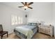Cozy bedroom with plantation shutters, ceiling fan, a comfortable bed, and a stylish side table at 5224 E San Palo Dr, Pahrump, NV 89061