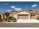 Charming single-story home with stone accents, a well-maintained lawn, and a convenient three-car garage at 5224 E San Palo Dr, Pahrump, NV 89061