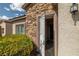 Inviting entryway with a decorative front door, stone accents, and lush landscaping at 5224 E San Palo Dr, Pahrump, NV 89061