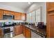 The kitchen has stainless steel appliances, wood cabinets, and granite countertops at 5224 E San Palo Dr, Pahrump, NV 89061
