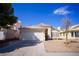 Charming single-story home featuring a two-car garage, low maintenance landscaping, and a tile roof at 5260 Del Lago Dr, Las Vegas, NV 89130