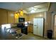 Bright kitchen with a modern appliance suite, wooden cabinets, and pendant lighting, perfect for cooking at 5260 Del Lago Dr, Las Vegas, NV 89130