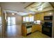 Well-lit kitchen with wooden cabinets, an island, and access to the living area, great for entertaining at 5260 Del Lago Dr, Las Vegas, NV 89130