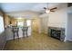 Open living area featuring a stone fireplace, kitchen bar, and ceiling fan at 5260 Del Lago Dr, Las Vegas, NV 89130