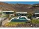 Backyard with a pool, spa, and putting green, set against a mountainous backdrop at 535 Serenity Point Dr, Henderson, NV 89012