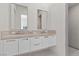 Bright bathroom featuring dual sinks, a large vanity, and a walk-in shower at 535 Serenity Point Dr, Henderson, NV 89012