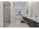 Elegant bathroom with a glass enclosed shower, dual sinks, and modern fixtures at 535 Serenity Point Dr, Henderson, NV 89012