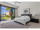 Bright bedroom with sliding glass doors to backyard and spiral staircase at 535 Serenity Point Dr, Henderson, NV 89012
