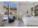 Inviting bedroom with large windows offering scenic views of mountains and stylish contemporary furnishings at 535 Serenity Point Dr, Henderson, NV 89012