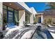 Contemporary home exterior boasting a striking blue door, reflecting pool, desert landscaping, and modern architectural design at 535 Serenity Point Dr, Henderson, NV 89012