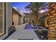 Modern home showcasing a tranquil water feature, elegant desert landscaping, and ambient lighting enhancing the outdoor space at 535 Serenity Point Dr, Henderson, NV 89012