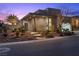 Modern home with a well-lit walkway, desert landscaping, and a multi-car garage at 535 Serenity Point Dr, Henderson, NV 89012