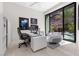 Modern home office features sleek desk, contemporary chairs, and large windows overlooking a tranquil backyard at 535 Serenity Point Dr, Henderson, NV 89012