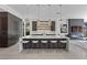 Modern kitchen with a large island, bar seating, minimalist pendant lighting, and sleek cabinetry at 535 Serenity Point Dr, Henderson, NV 89012