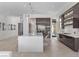 Bright and airy kitchen with a large island, modern appliances, sleek cabinetry, and a view of the backyard at 535 Serenity Point Dr, Henderson, NV 89012