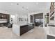 Open kitchen featuring a large island with barstool seating and modern dark wood cabinetry and appliances at 535 Serenity Point Dr, Henderson, NV 89012