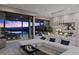 Open-concept living room with modern sectional, sliding glass doors, and seamless indoor-outdoor flow at 535 Serenity Point Dr, Henderson, NV 89012