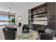 Modern living room with sleek built-in bar, dining area, and mountain views at 535 Serenity Point Dr, Henderson, NV 89012