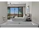 Main bedroom with a scenic view and a luxurious soaking tub at 535 Serenity Point Dr, Henderson, NV 89012