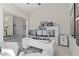 Bright office space featuring a modern white desk, multiple monitors, glass enclosed wine storage, and contemporary decor at 535 Serenity Point Dr, Henderson, NV 89012
