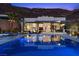 Modern pool with outdoor seating and a fire pit offers the perfect space to unwind and enjoy the beautiful surroundings at 535 Serenity Point Dr, Henderson, NV 89012