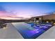 Relaxing infinity pool featuring in-pool lounge chairs and a built-in TV for luxurious outdoor entertainment at 535 Serenity Point Dr, Henderson, NV 89012
