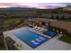 Aerial view of a luxury pool with lounge chairs, a hot tub, and outdoor entertainment area at 535 Serenity Point Dr, Henderson, NV 89012