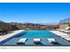 Infinity pool and lounge chairs overlooking the city, creating a serene and luxurious atmosphere at 535 Serenity Point Dr, Henderson, NV 89012