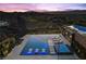 Luxury infinity pool and spa overlooking a golf course, perfect for relaxation, featuring built-in loungers and night lighting at 535 Serenity Point Dr, Henderson, NV 89012