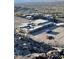 Aerial view of modern home under construction near other homes and trees at 563 Rock Peak Dr, Henderson, NV 89012