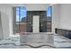 Bathroom featuring sleek cabinets, marble accent wall, and large windows offering scenic views at 563 Rock Peak Dr, Henderson, NV 89012