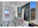 Modern bathroom design featuring floor-to-ceiling windows, marble wall, and artistic marble flooring at 563 Rock Peak Dr, Henderson, NV 89012