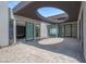 Modern home featuring an exterior courtyard with expansive sliding glass doors leading to interior spaces at 563 Rock Peak Dr, Henderson, NV 89012