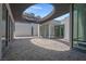 Modern home design with a circular cutout in the overhanging roof and large sliding glass doors at 563 Rock Peak Dr, Henderson, NV 89012