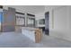 Partially-finished modern kitchen with gray cabinets, center island, and large window views at 563 Rock Peak Dr, Henderson, NV 89012