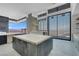 Spacious kitchen with island, floor-to-ceiling windows offering panoramic city views, unfinished countertops at 563 Rock Peak Dr, Henderson, NV 89012
