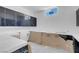Well-lit laundry room with black cabinets and ample countertop space for folding and organizing at 563 Rock Peak Dr, Henderson, NV 89012