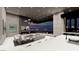 Living room with fireplace, television, modern furniture, and a gorgeous night view at 563 Rock Peak Dr, Henderson, NV 89012