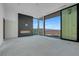 The living room boasts floor-to-ceiling windows and a sleek fireplace for elegant style at 563 Rock Peak Dr, Henderson, NV 89012