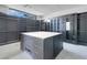 Spacious walk-in closet featuring custom shelving, drawers, and a center island for optimal organization at 563 Rock Peak Dr, Henderson, NV 89012
