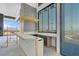 The wet bar features a custom bar and counter, offering beautiful outdoor views from the large windows at 563 Rock Peak Dr, Henderson, NV 89012
