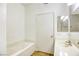 A white bathroom features a tub, a toilet, and a vanity with a sink and a mirrored cabinet at 5751 E Hacienda Ave # 243, Las Vegas, NV 89122