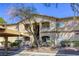 Charming exterior view of the condo complex featuring a mix of desert landscaping and reserved parking at 5751 E Hacienda Ave # 243, Las Vegas, NV 89122